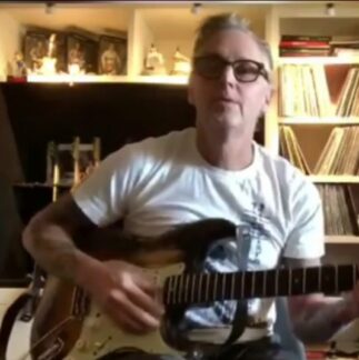Mike McCready plays a song in loving memory of Tom Husman